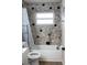 Updated bathroom with a shower/tub and stylish tile work at 11261 Redgate St, Spring Hill, FL 34609