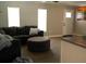 Bright living room featuring a sectional sofa, ottoman, and wood-look flooring at 11261 Redgate St, Spring Hill, FL 34609