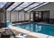 Sparkling swimming pool with screened enclosure at 11261 Redgate St, Spring Hill, FL 34609