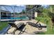 Spacious patio with lounge chairs near the pool at 12289 Glen Haven St, Spring Hill, FL 34609