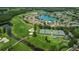 Aerial view of community, featuring lake, golf course, and tennis courts at 1240 Winding Willow Dr, Trinity, FL 34655