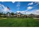 Clubhouse exterior view showcasing landscaping and flag at 1240 Winding Willow Dr, Trinity, FL 34655