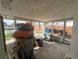 Enclosed sunroom, offering a unique space with waterfront views and potential for custom renovation at 13639 Frances Ave, Hudson, FL 34667