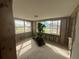 Bright sunroom, featuring many windows and natural light, offering relaxing view of the outdoors and renovation opportunities at 13639 Frances Ave, Hudson, FL 34667