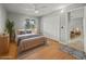 Staged bedroom features wood floors, closet and furniture at 230 Thorn Tree Pl # 230, Brandon, FL 33510