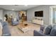 Virtual staging: Living room with neutral furnishings, TV and dining area at 230 Thorn Tree Pl # 230, Brandon, FL 33510
