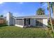 House exterior showcasing backyard and screened porch at 3104 Domino Dr, Holiday, FL 34691