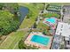 Aerial view showing two pools, tennis courts, and landscaping at 3416 Lori Ln # 4, New Port Richey, FL 34655