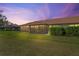 Spacious backyard with a screened patio, lush greenery, and a tranquil setting at 3416 Lori Ln # 4, New Port Richey, FL 34655
