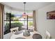 Bright dining area with a round table and chairs, overlooking a garden view at 3416 Lori Ln # 4, New Port Richey, FL 34655