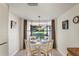 Small dining area with a round table and four chairs, overlooking a garden view at 3416 Lori Ln # 4, New Port Richey, FL 34655