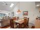 Spacious dining area with a wooden table and chairs, adjacent to a living room at 3416 Lori Ln # 4, New Port Richey, FL 34655