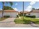 Exterior view of two villas with attached garages and a neatly landscaped front yard at 3416 Lori Ln # 4, New Port Richey, FL 34655