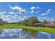 Home exterior showcasing water view and lush landscaping at 3416 Lori Ln # 4, New Port Richey, FL 34655