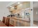 Kitchen features a breakfast bar with wood cabinets and granite countertops at 3416 Lori Ln # 4, New Port Richey, FL 34655