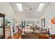 Bright living room with vaulted ceilings, hardwood floors, and view to a canal at 3416 Lori Ln # 4, New Port Richey, FL 34655