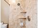 Bathroom with shower and beige marble tile at 4078 Orient Dr, Hernando Beach, FL 34607