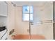 Shower and tub with pink tile and glass enclosure at 4078 Orient Dr, Hernando Beach, FL 34607