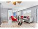 Bright living room featuring a gray couch and red accent chair at 4078 Orient Dr, Hernando Beach, FL 34607