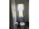 Practical bathroom features a toilet and storage solutions at 6434 Garvey Dr, New Port Richey, FL 34652