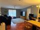 Cozy living room with ample seating and a large area rug; features a ceiling fan and natural light at 6434 Garvey Dr, New Port Richey, FL 34652