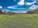 Expansive green golf course with a pond in the background at 6594 Brambleleaf Dr, Spring Hill, FL 34606