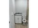 Clean bathroom with a white vanity, granite countertop, toilet, and shower at 7142 Carlow St, New Port Richey, FL 34653