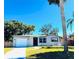 Newly renovated home with a white garage door and red front door, featuring a well-manicured lawn at 7142 Carlow St, New Port Richey, FL 34653