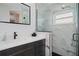 Updated bathroom with dark vanity, quartz countertop and walk-in shower at 7562 Heather Walk Dr, Weeki Wachee, FL 34613