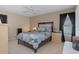 Bedroom with a queen-size bed, ceiling fan, and ample closet space at 7562 Heather Walk Dr, Weeki Wachee, FL 34613