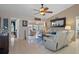 Living room with light beige couches and view into kitchen at 7562 Heather Walk Dr, Weeki Wachee, FL 34613