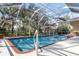 Relax and swim in this screened pool with spa, surrounded by lush landscaping at 9144 Alexandria Dr, Weeki Wachee, FL 34613