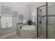 Elegant bathroom with soaking tub, walk-in shower, and tile flooring at 9728 Milano Dr, Trinity, FL 34655