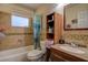 Clean bathroom with shower/tub combo and wood vanity at 10525 Hilltop Dr, New Port Richey, FL 34654