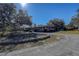 Brick ranch home with circular driveway and landscaping at 10525 Hilltop Dr, New Port Richey, FL 34654