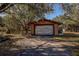 Detached garage with a large roll-up door at 10525 Hilltop Dr, New Port Richey, FL 34654