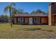 Brick house with a white door and windows, nicely landscaped at 10525 Hilltop Dr, New Port Richey, FL 34654
