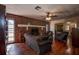 Living room with a brick fireplace, hardwood floors and comfortable seating at 10525 Hilltop Dr, New Port Richey, FL 34654