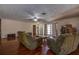 Living room with hardwood floors, comfy sofas, and a ceiling fan at 10525 Hilltop Dr, New Port Richey, FL 34654