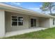 Covered patio with sliding glass door access from interior at 11359 Flower Ave, Weeki Wachee, FL 34613