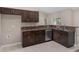 Modern kitchen with dark wood cabinets and granite countertops at 11359 Flower Ave, Weeki Wachee, FL 34613