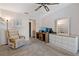 Bedroom with dresser, seating, and access to a balcony at 12141 Spartan Way # 204, Hudson, FL 34667