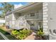 Building exterior with stairs and landscaping at 12141 Spartan Way # 204, Hudson, FL 34667