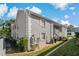 Gray building exterior with white trim, landscaping, and a stairway at 12141 Spartan Way # 204, Hudson, FL 34667