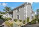 Gray building exterior with landscaping and walkway at 12141 Spartan Way # 204, Hudson, FL 34667