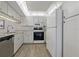 Kitchen with white cabinets, granite counters, and stainless steel appliances at 12141 Spartan Way # 204, Hudson, FL 34667
