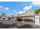 Exterior view of building and carport parking at 12141 Spartan Way # 204, Hudson, FL 34667