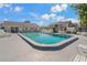 Community swimming pool with lounge chairs and surrounding patio at 12141 Spartan Way # 204, Hudson, FL 34667