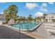Community pool with lounge chairs and a surrounding patio at 12141 Spartan Way # 204, Hudson, FL 34667