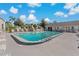 Community pool with lounge chairs and a surrounding patio at 12141 Spartan Way # 204, Hudson, FL 34667